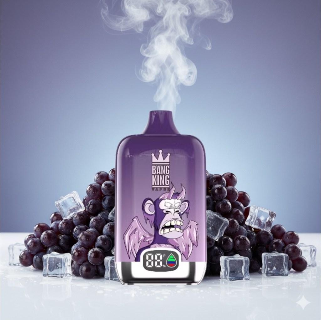 A purple vape device with a cartoon monkey design, surrounded by fresh grapes and ice cubes, emitting vapor.