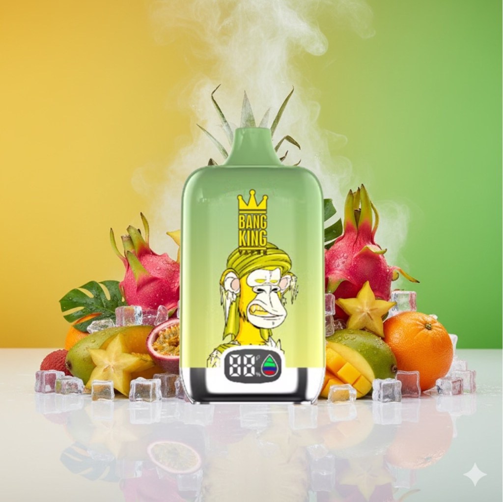 A colorful vape device with a cartoon monkey design stands in front of an assortment of fresh fruits and ice, set against a gradient green and yellow background.